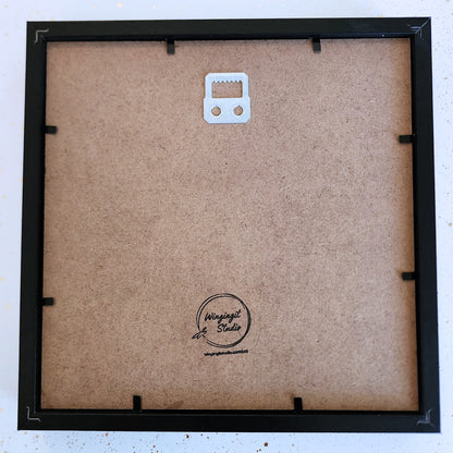 Back of a framed shadow box with visible brand logo "Wingingit Studio".