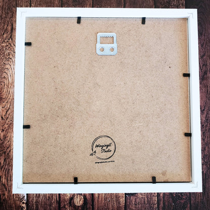 Back of a framed shadow box with visible brand logo "Wingingit Studio".